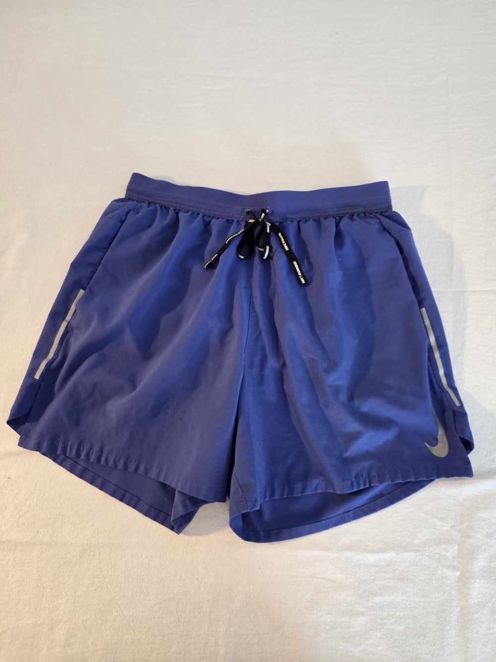 Nike Women's Flex Sttide Blue Running Shorts with Reflective Details.